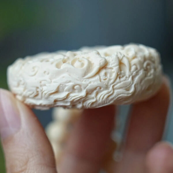 Hand - carved Double - sided Mammoth Ivory Pendant with Dragon and Phoenix Patterns. It can be used as a hanging ornament, a necklace pendant, a Buddhist bead pendant, or a trendy sweater chain.