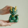 1fb0390e-9ef7-4fce-a096-853d5342f2de-1.jpg The mascot of wealth-attracting divine dragon ornament for desktop, which means always having money, is used for home living rooms, hallways, and office decoration.