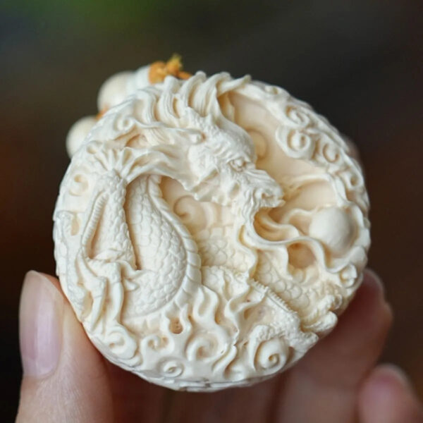 Hand - carved Double - sided Mammoth Ivory Pendant with Dragon and Phoenix Patterns. It can be used as a hanging ornament, a necklace pendant, a Buddhist bead pendant, or a trendy sweater chain.