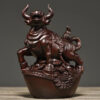 Solid ebony wood carving of the twelve Chinese zodiac animals, solid wood ox ornaments. It is a modern handicraft gift for home decoration in the living room or for office use.