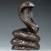Solid ebony wood carving of the snake among the twelve Chinese zodiac animals (cobra) ornaments. They can attract wealth and are used for home and office decoration as well as feng shui purposes. They are handicraft items made of mahogany.