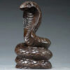 Solid ebony wood carving of the snake among the twelve Chinese zodiac animals (cobra) ornaments. They can attract wealth and are used for home and office decoration as well as feng shui purposes. They are handicraft items made of mahogany.