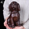 Wood-carved dog ornaments, made of solid ebony wood, the dog of the Chinese zodiac. They are cute home decoration items and handicrafts made of mahogany.
