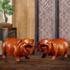 Pear wood carving of the pig, redwood and ebony wood carvings of the pig among the twelve Chinese zodiac animals for attracting wealth. They are tabletop birthday gifts, the lucky golden pig ornaments.