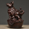 Solid ebony wood carving of the twelve Chinese zodiac animals, solid wood ox ornaments. It is a modern handicraft gift for home decoration in the living room or for office use.